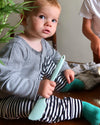 A toddler holding the GIR Mini Spatula. 