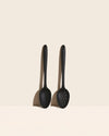 Ultimate Perforated Spoon & Spoon Set displayed against a light background, showcasing two black cooking spoons.